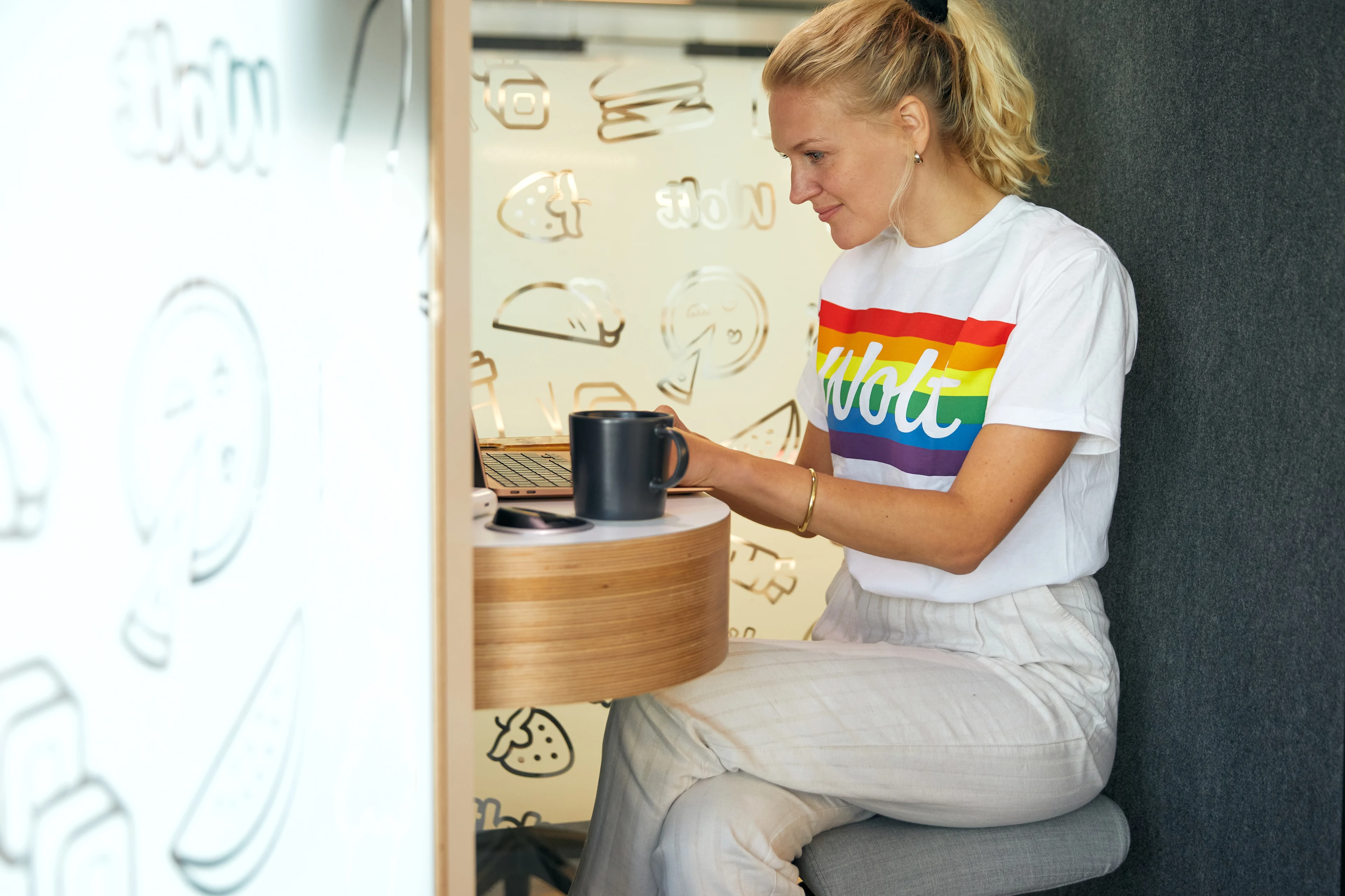 Wolt HQ - woman working on laptop in booth