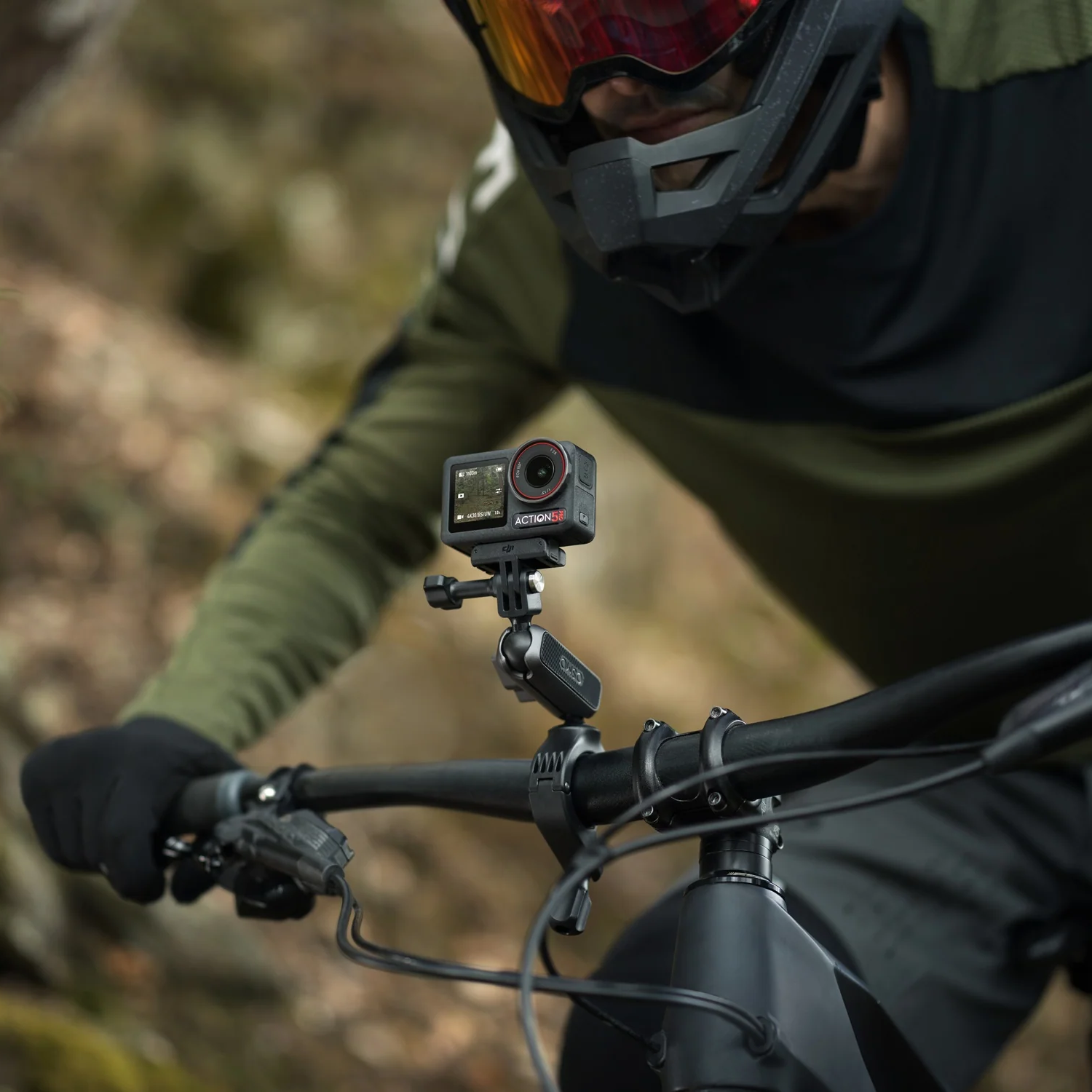 DJI Osmo 5 Pro attached to handle bar of a bike.