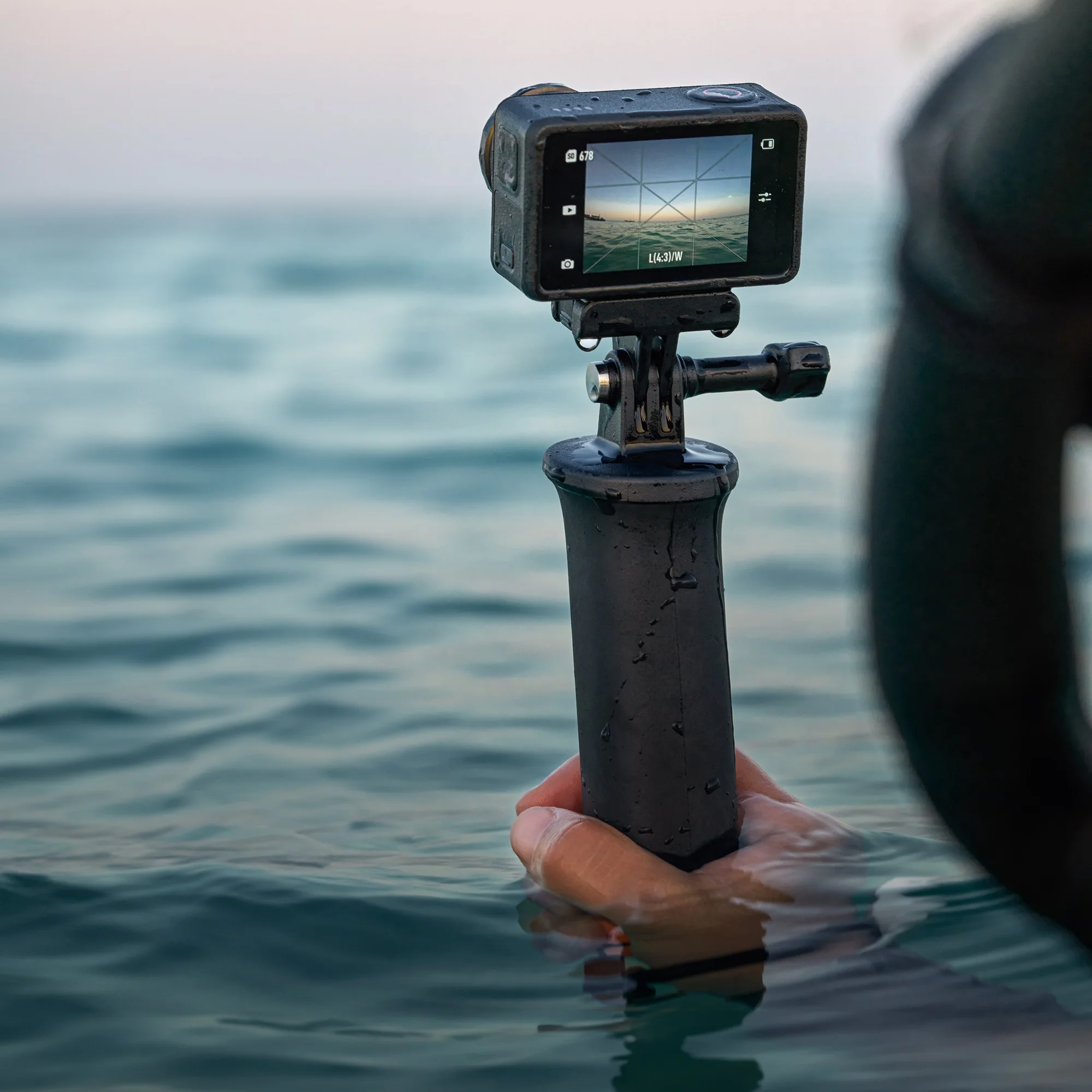 DJI Osmo 5 Pro with handle in the water.
