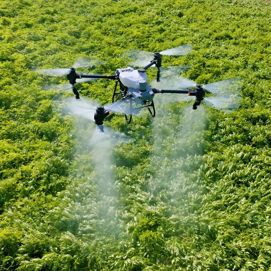 DJI Agras flying over a field.