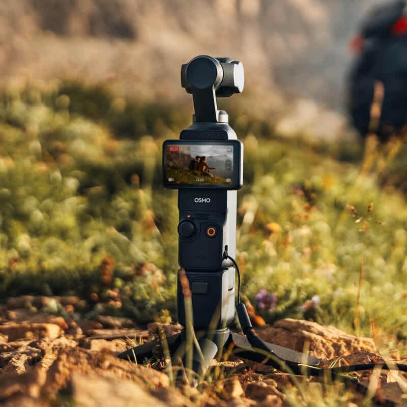 DJI Osmo Pocket 3 Mini Tripod in a field.