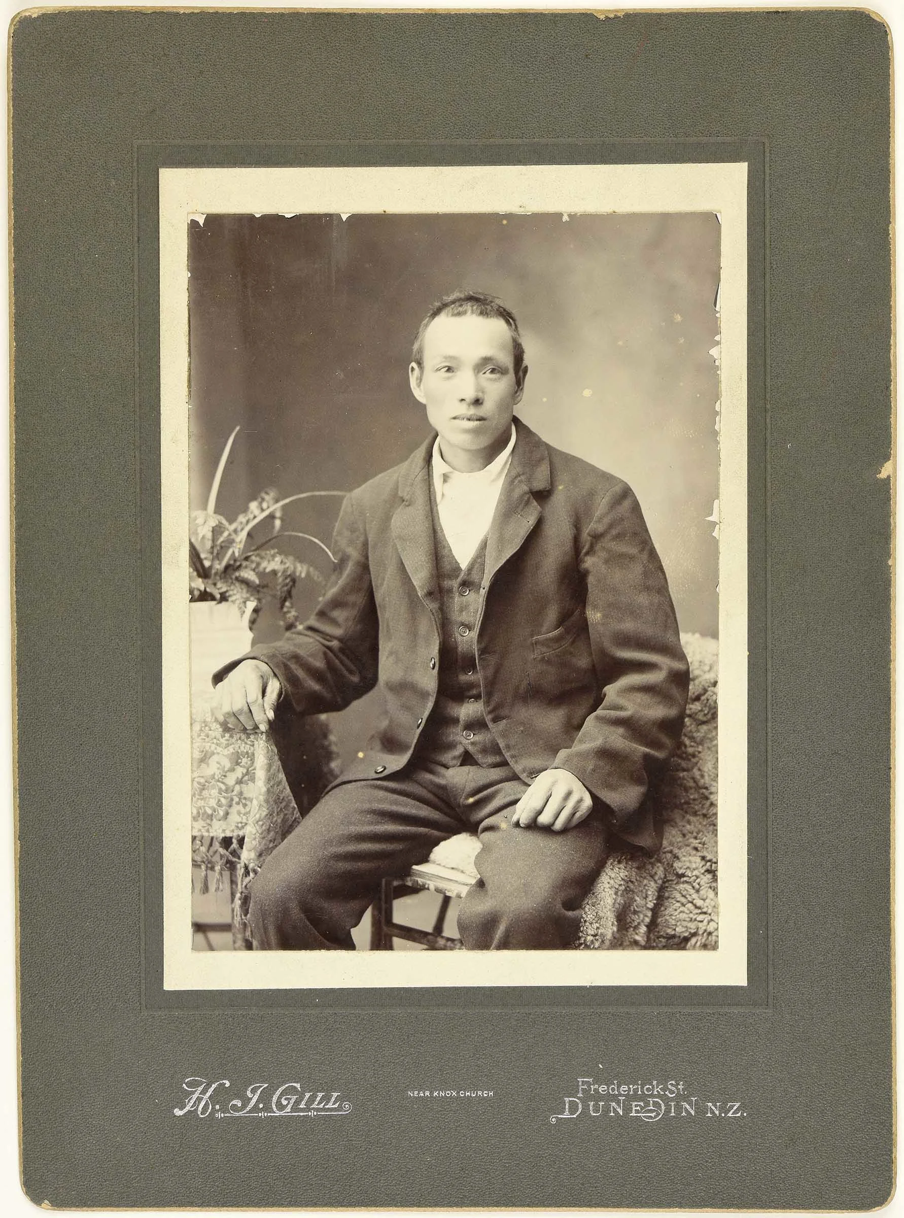 Sepia photo portrait of a seated Chinese man