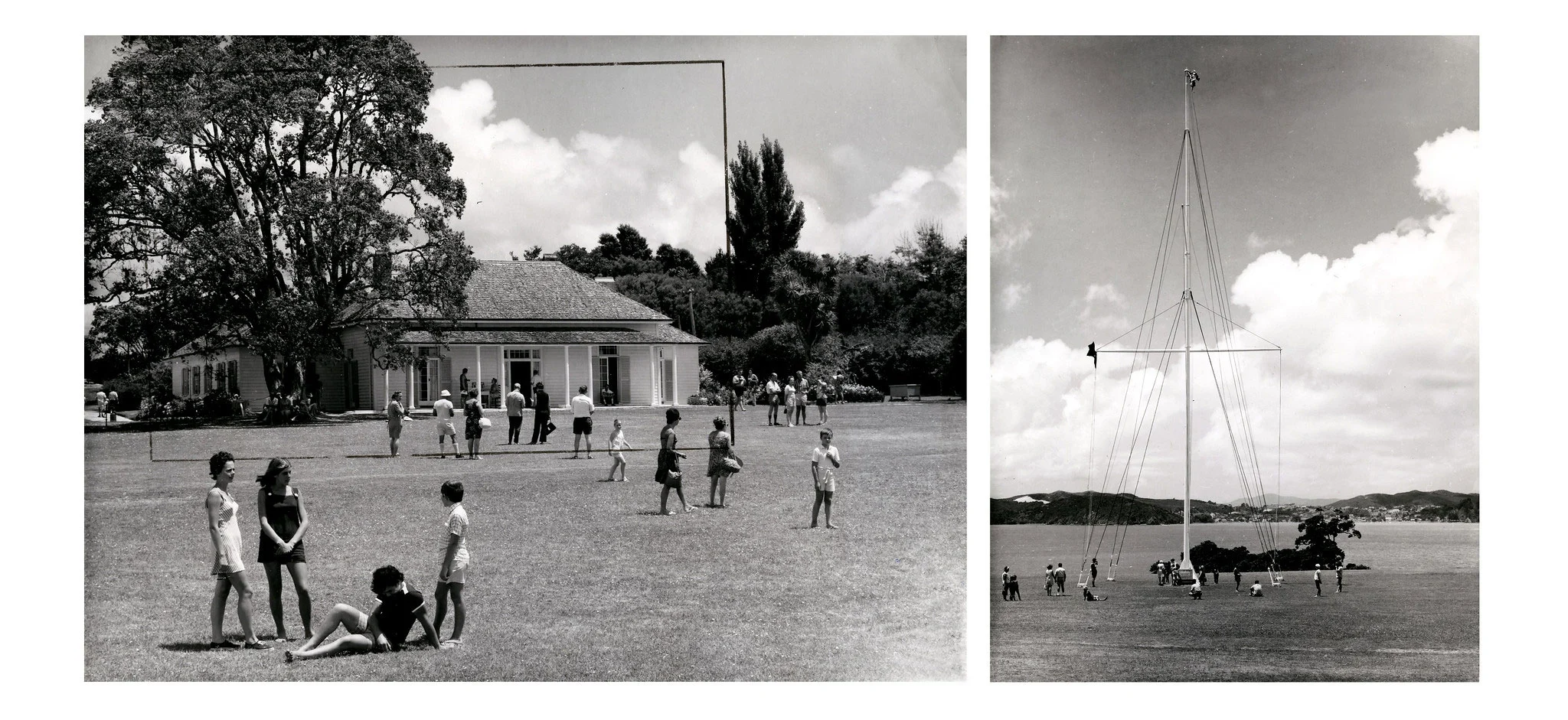 People standing on a grass ground near a tall flagstaff and a white weatherboard house.