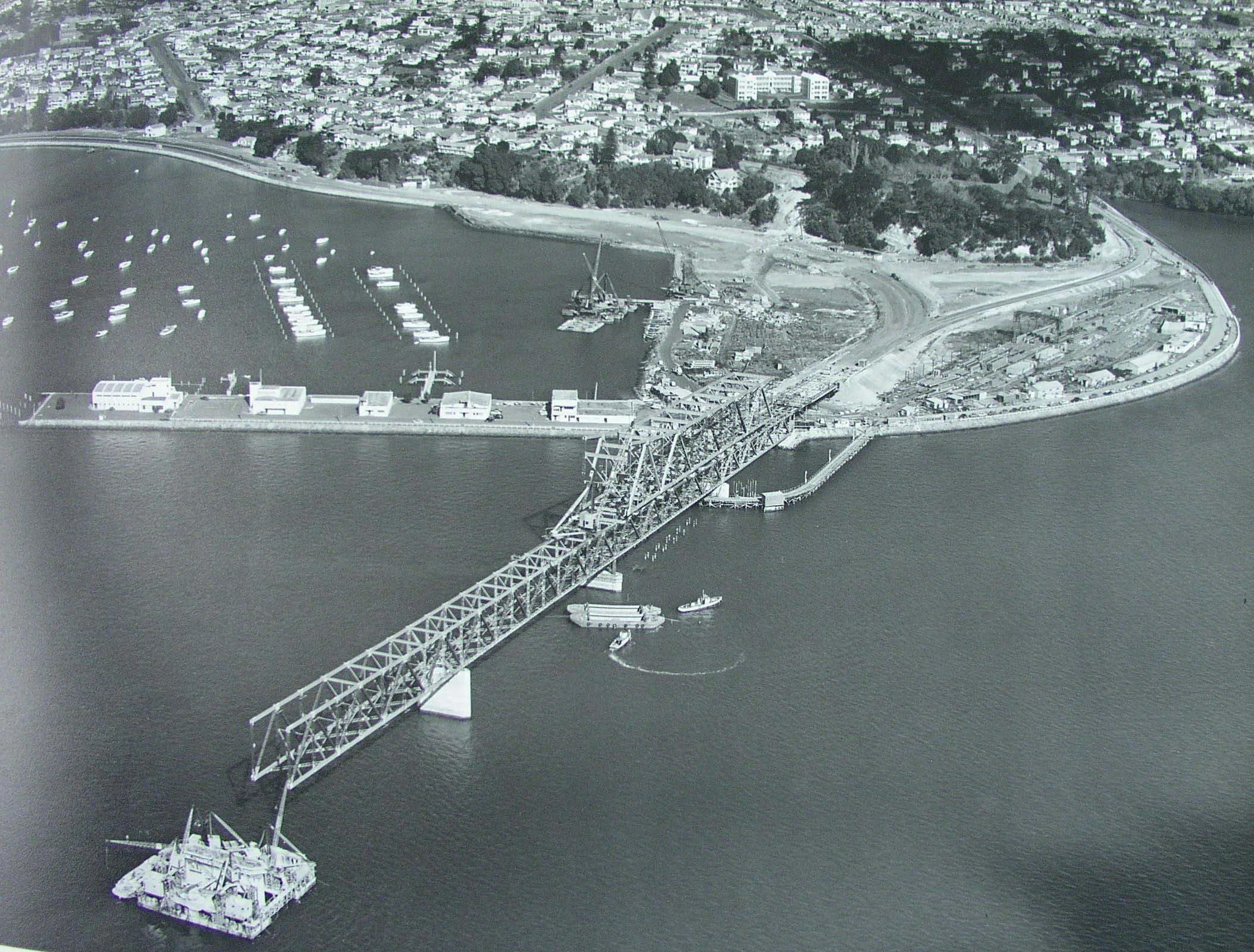 Aerial photo showing construction of Auckland Harbour Bridge from Point Erin