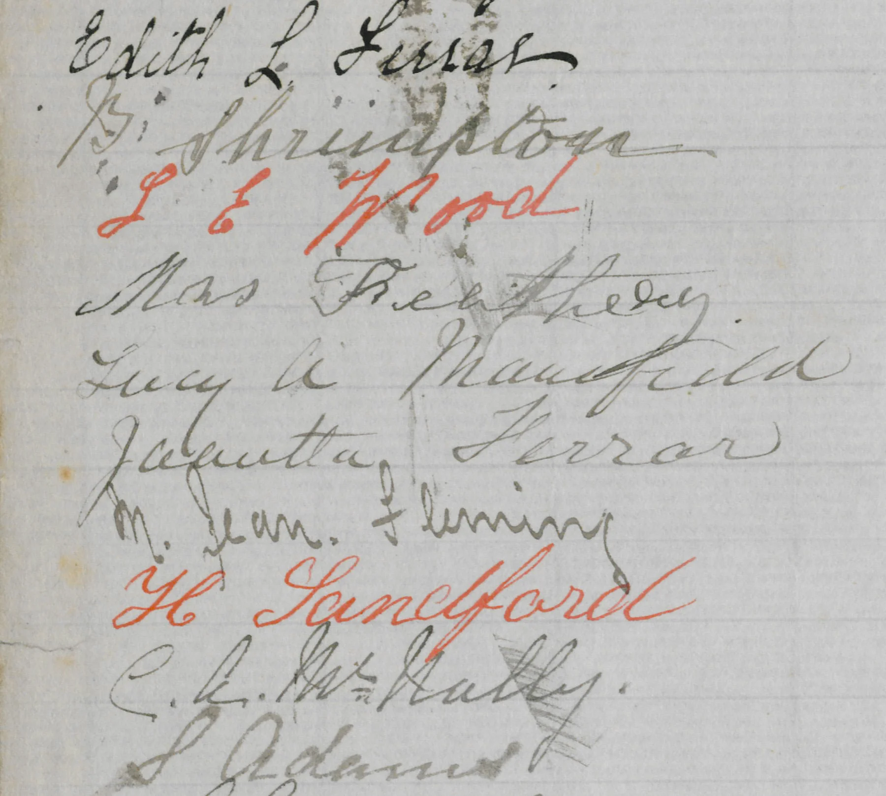 Handwritten words in black and red ink on old paper