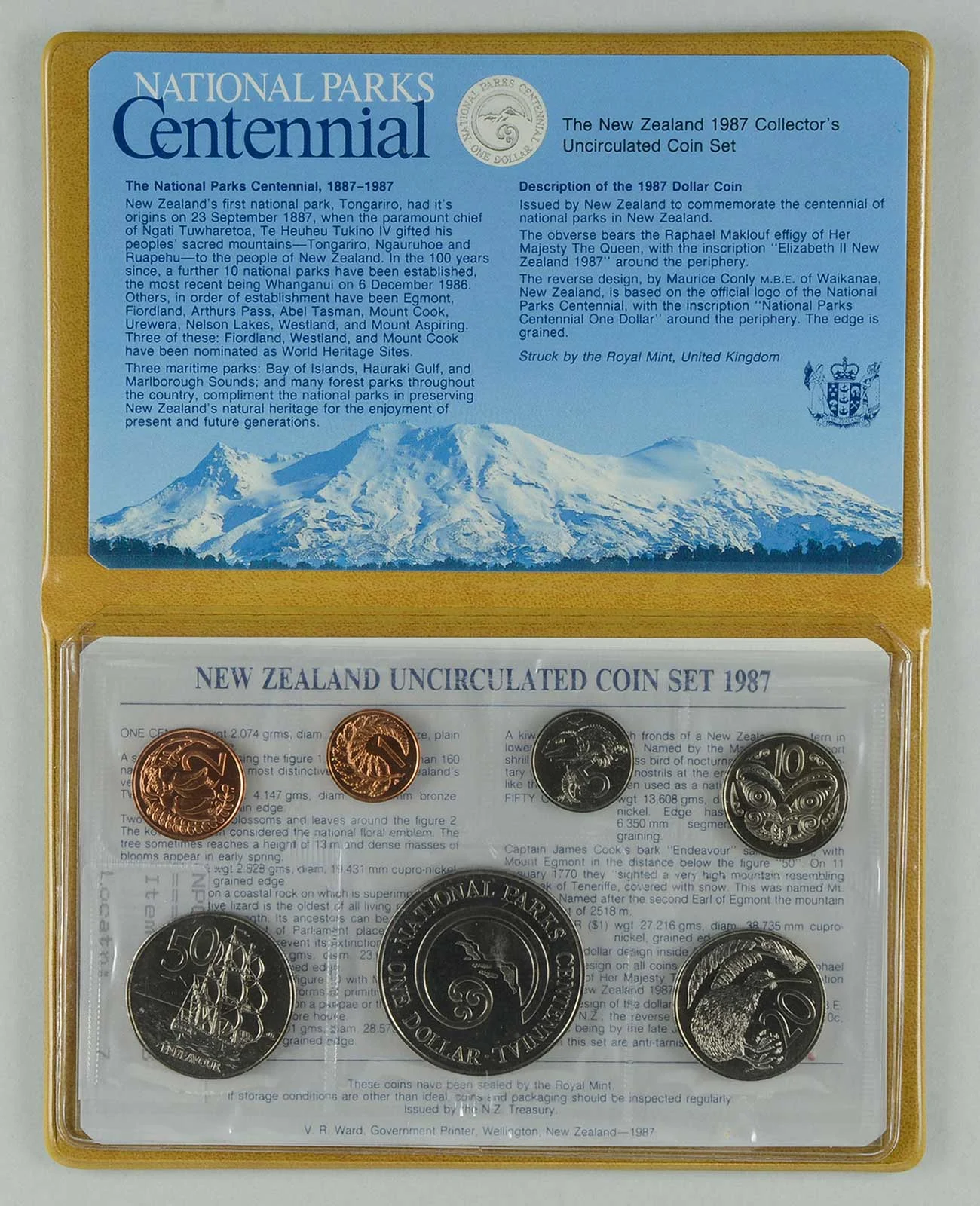 A set of 7 coins and information written on the top cover  