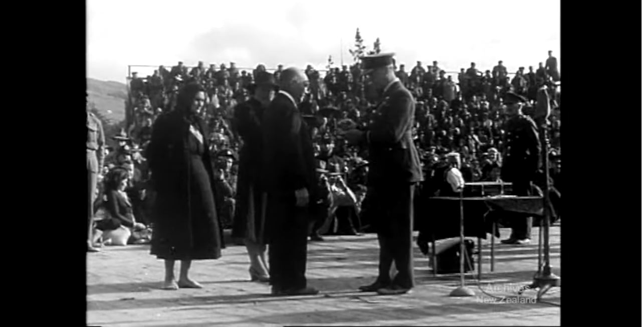 A still from 'Weekly Review No.112'. A fallen soldier's parents are presented with a Victoria Cross medal at a ceremony.