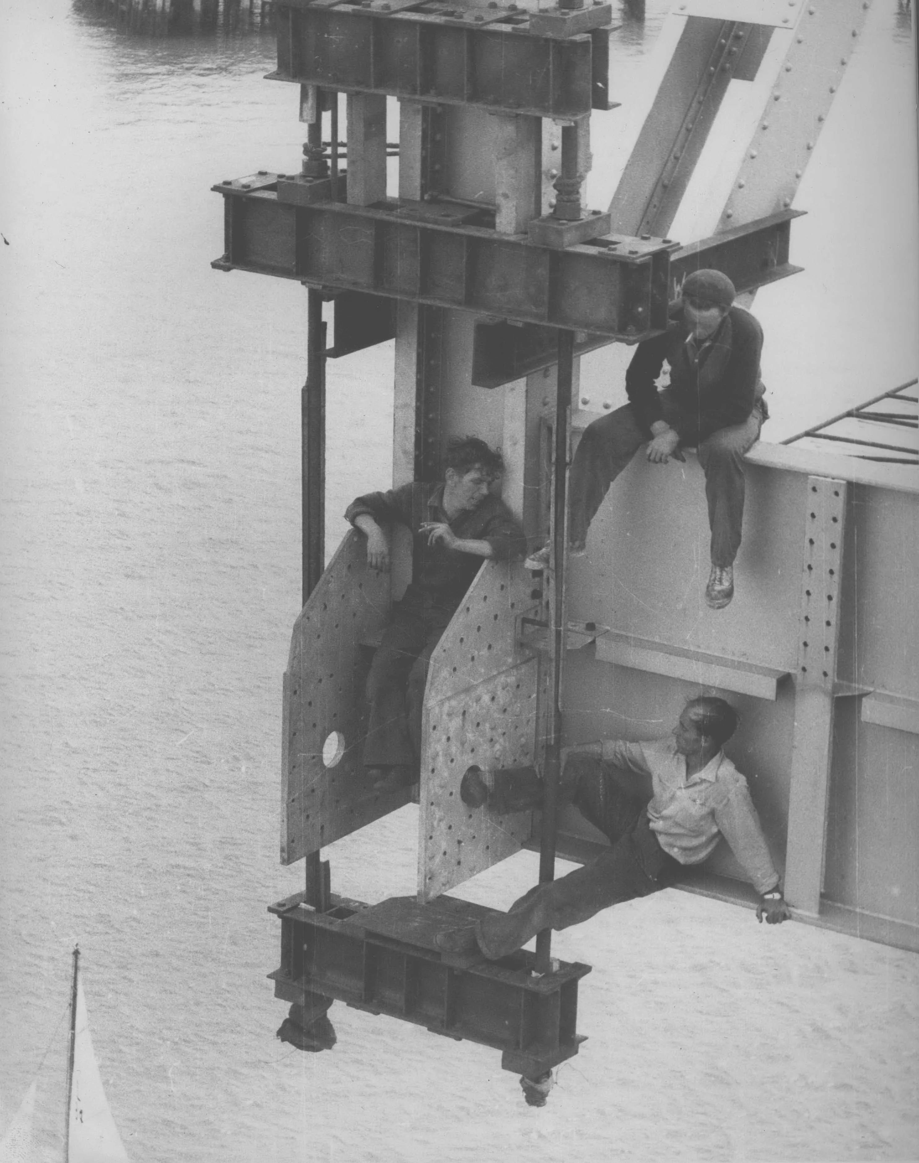 Worker sitting on steel erector