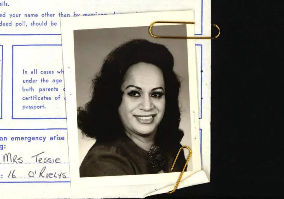 Passport photo of Carmen Rupe attached to application file.