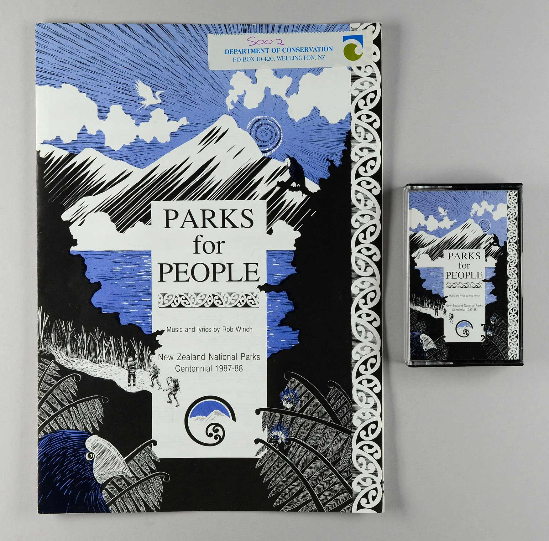 Cassette tape with a cover of mountains and blue sky, words written in the center 'Parks for People'