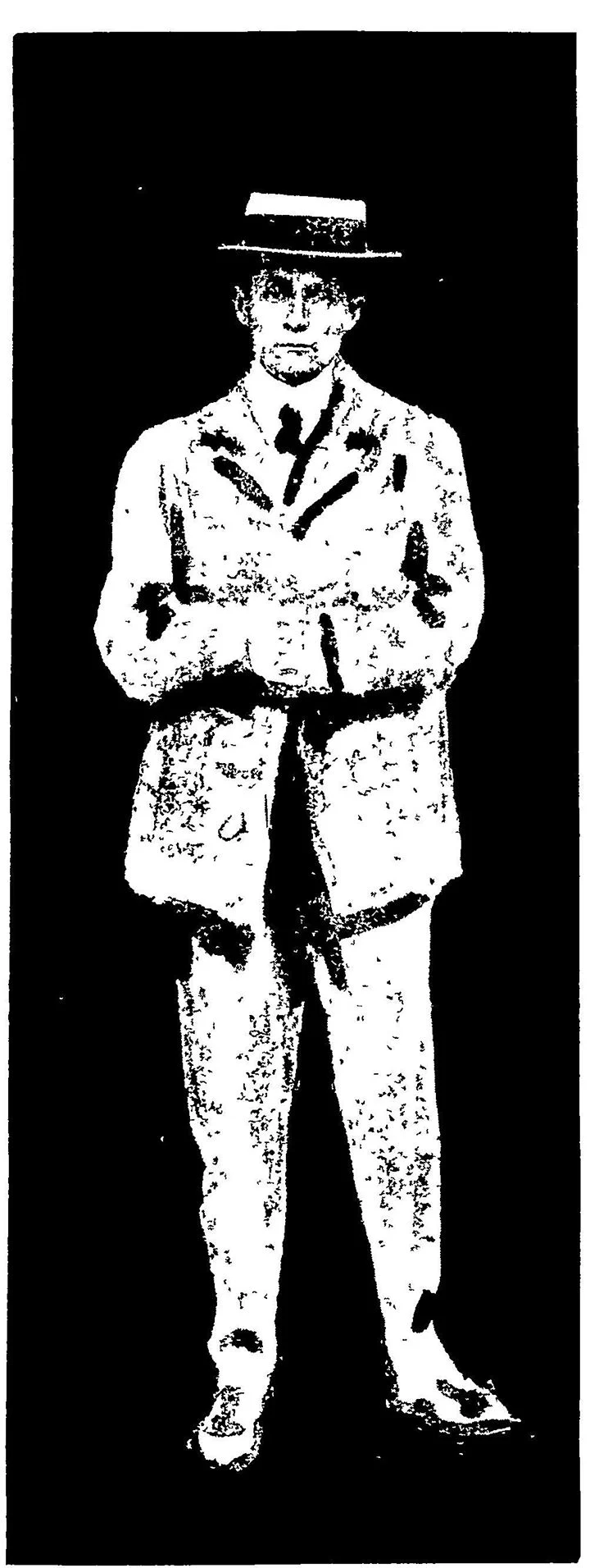 black and white image of a woman wearing a mens suit and hat