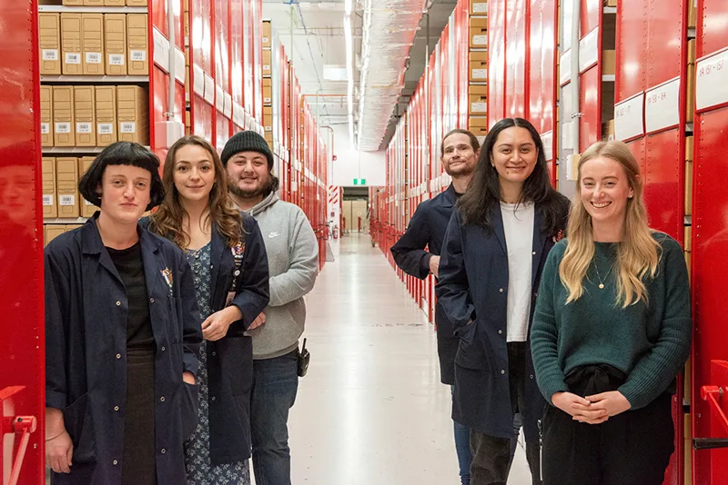 Six members of the AIMS Archives team standing in the repository