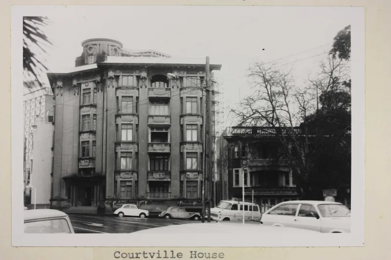 Black and white image of a large building from the street