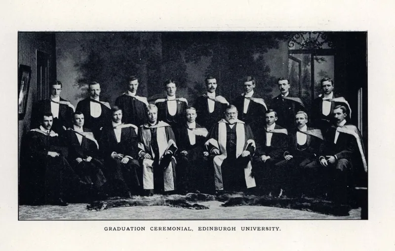 Photo of men posing for a photo in graduation wear