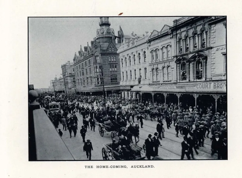 Black and white photo showing a procession walking down a street in Auckland