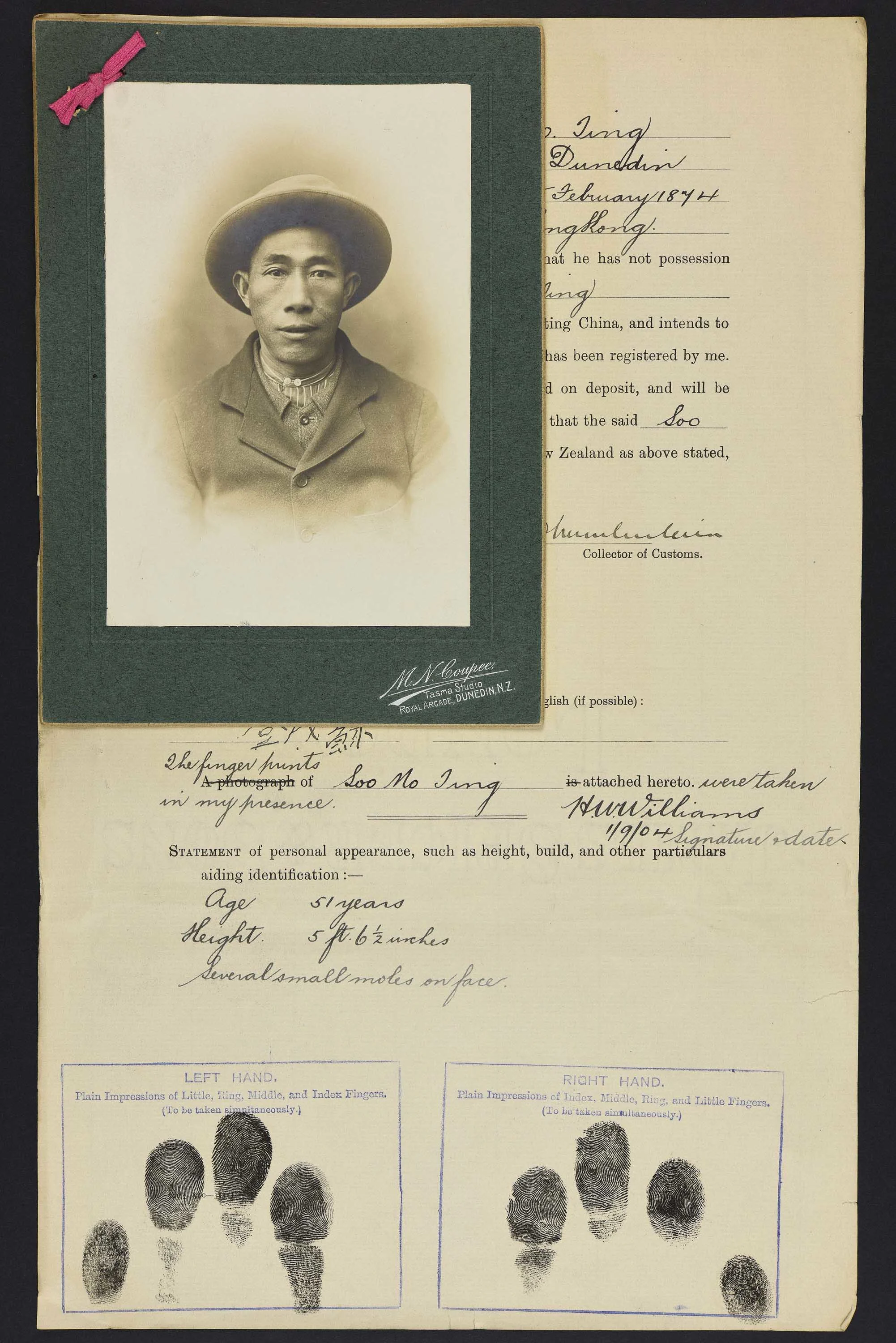Sepia photo portrait of a Chinese man in a wide brimmed hat pinned to his immigration papers
