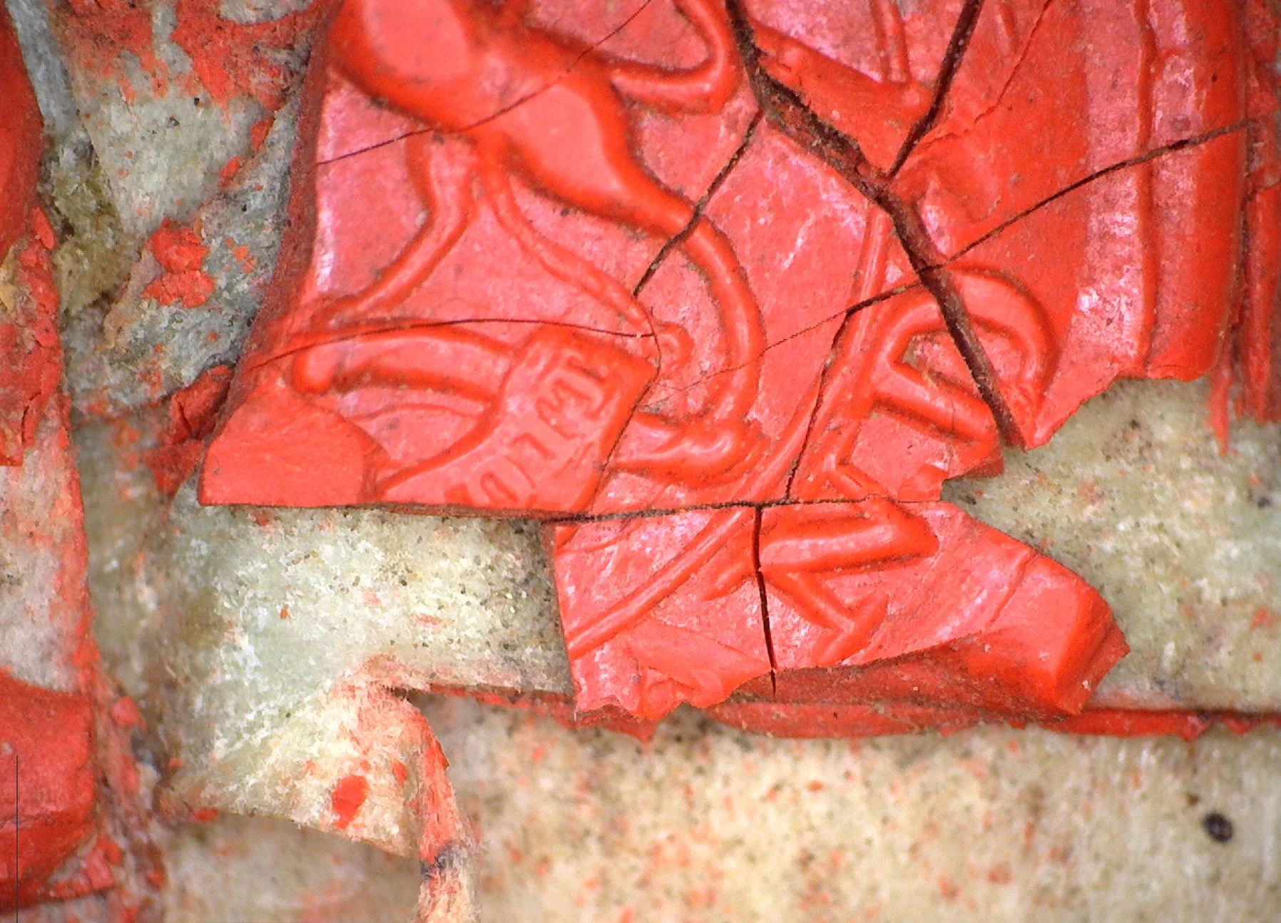 Bright rea color broken seal on a yellowed old sheet