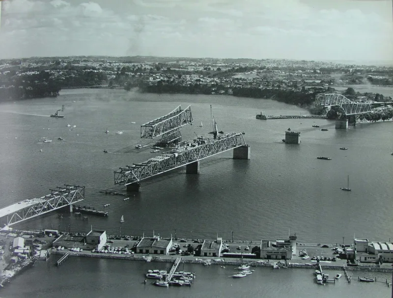 Aerial photo showing construction of Auckland Harbour Bridge on 29 November 1958