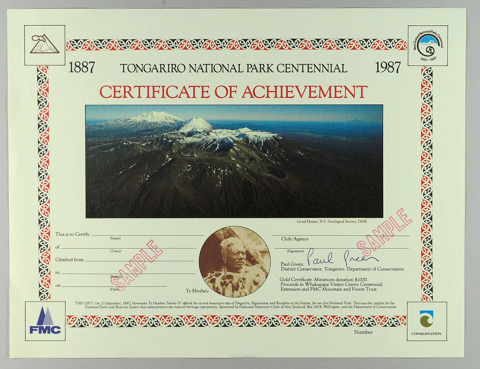 A certificate on a light green paper with a photo of a snow-clad mountain in the center and a colourful border
