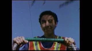 A still from 'Running for Empties'. A young man wearing a hi-vis vest holds the handlebar of a trolley.