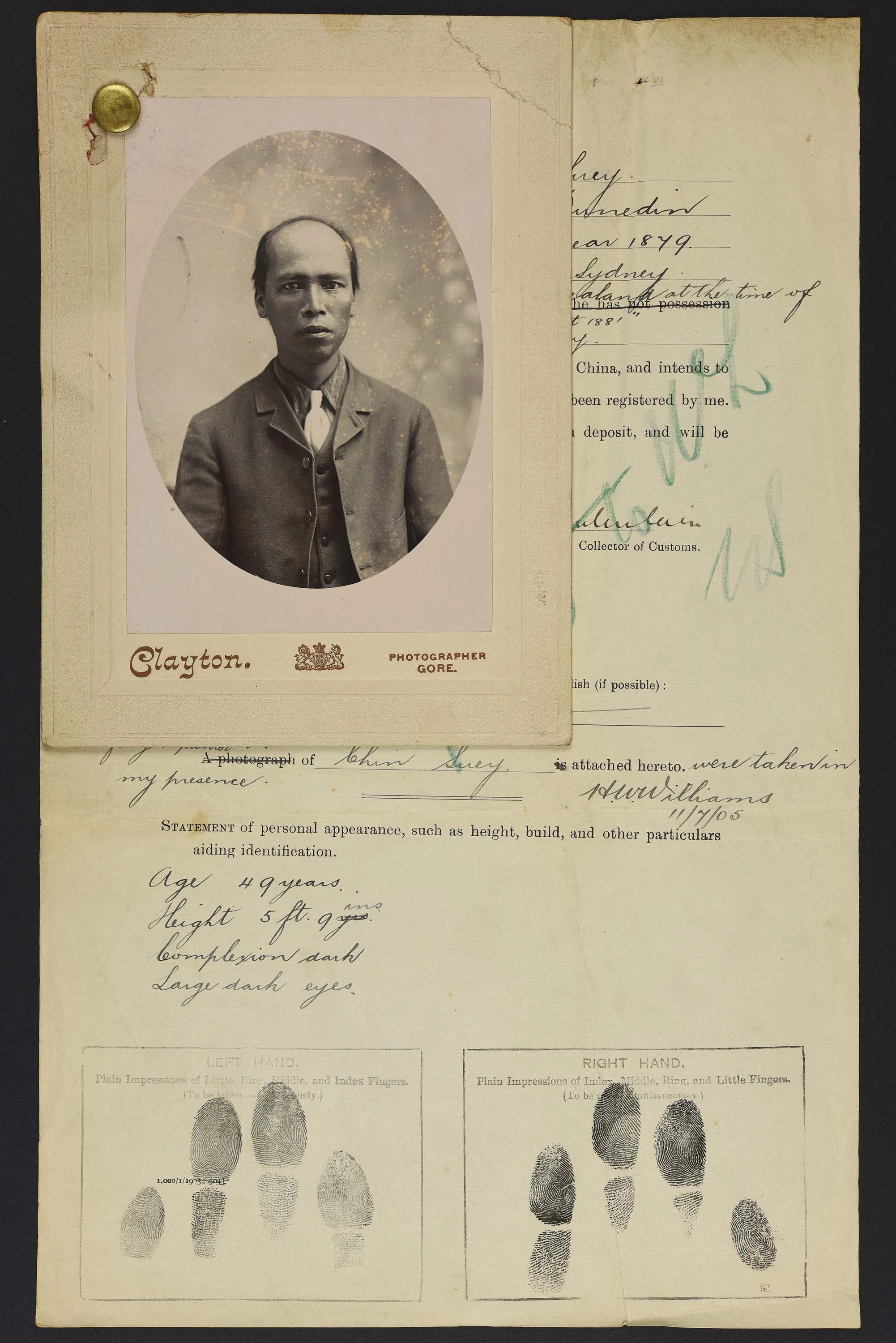 Sepia photo portrait of a Chinese man attached to his immigration papers.