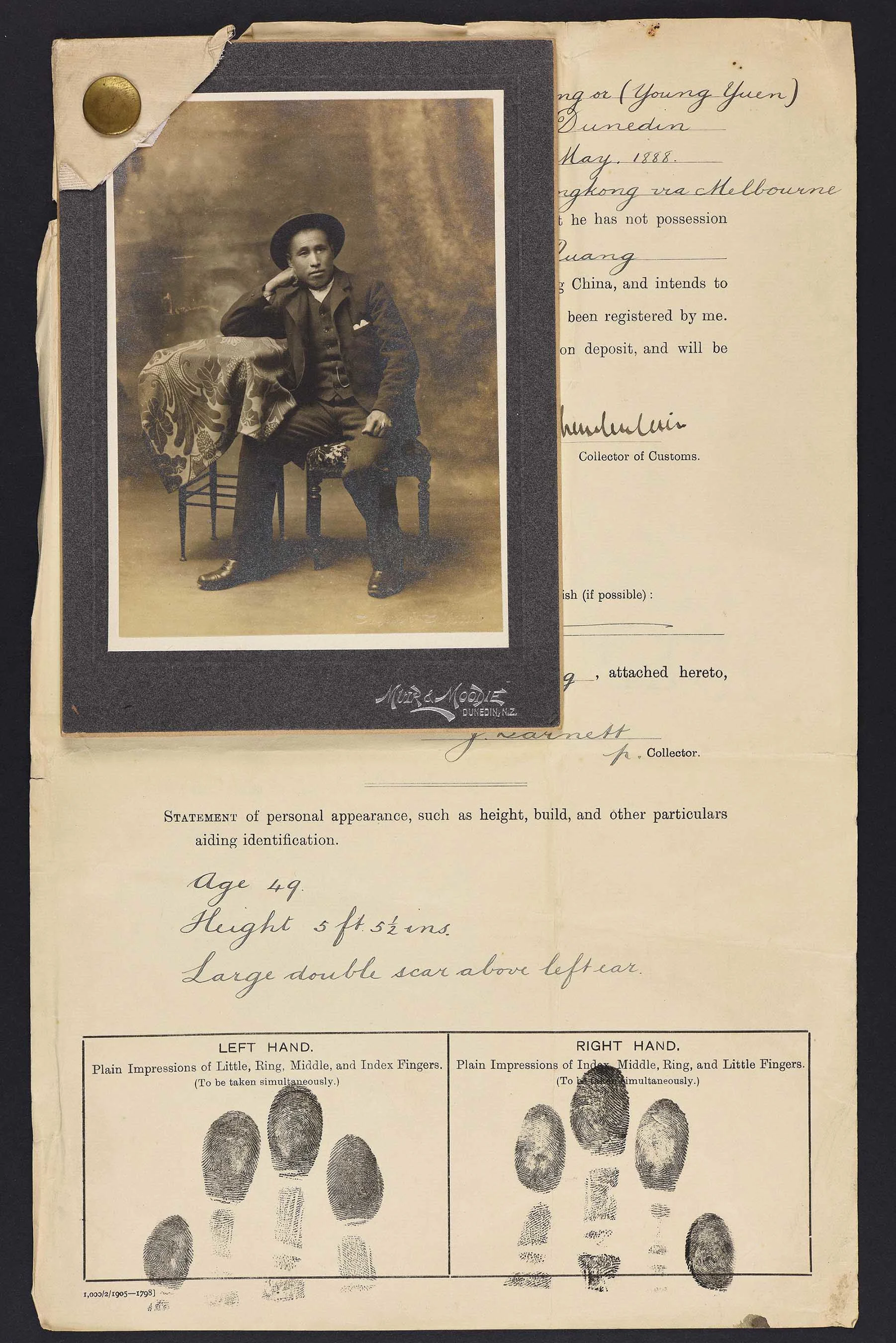 Sepia photo of a seated Chinese man resting on his right hand. Attached to his immigration papers.