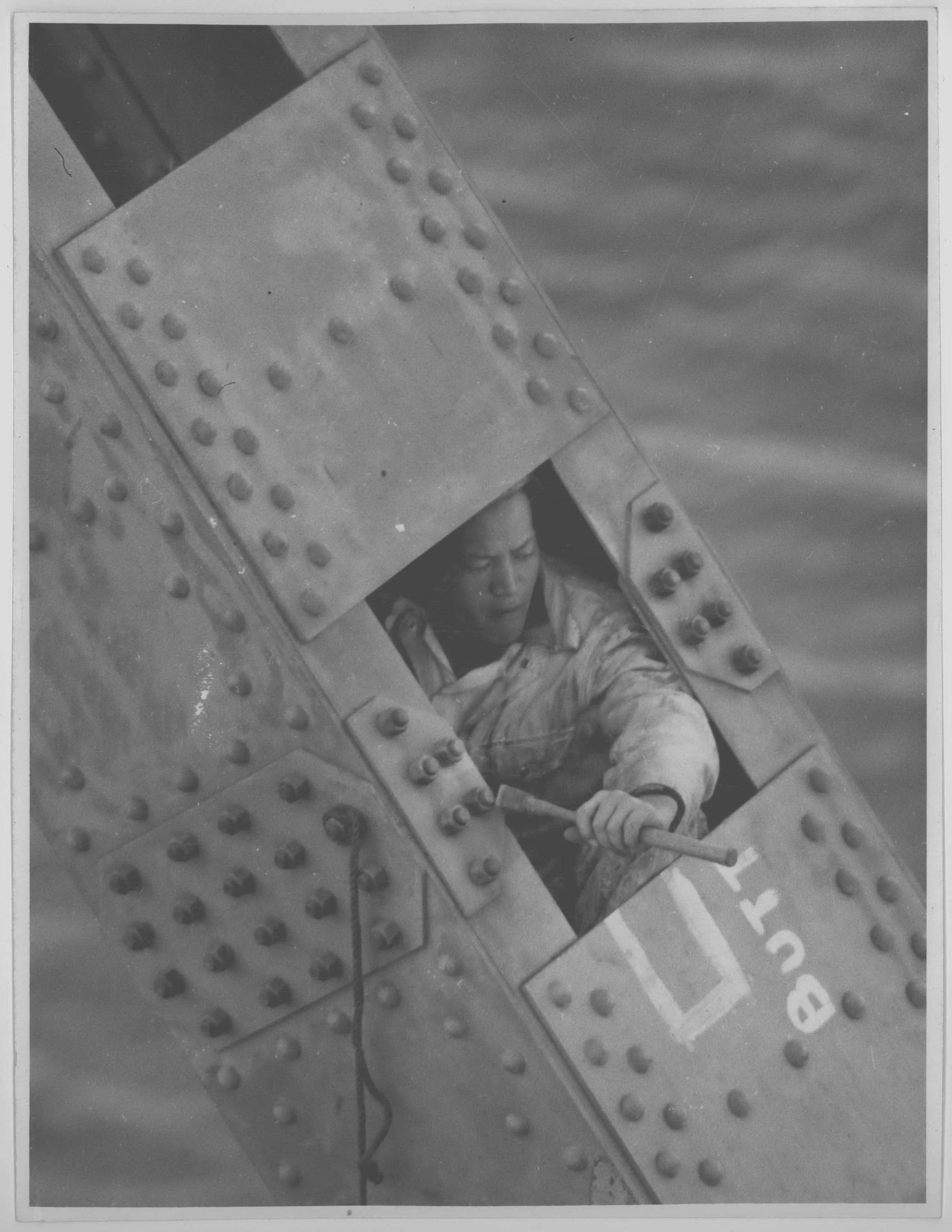 A male steel erector working on the bridge