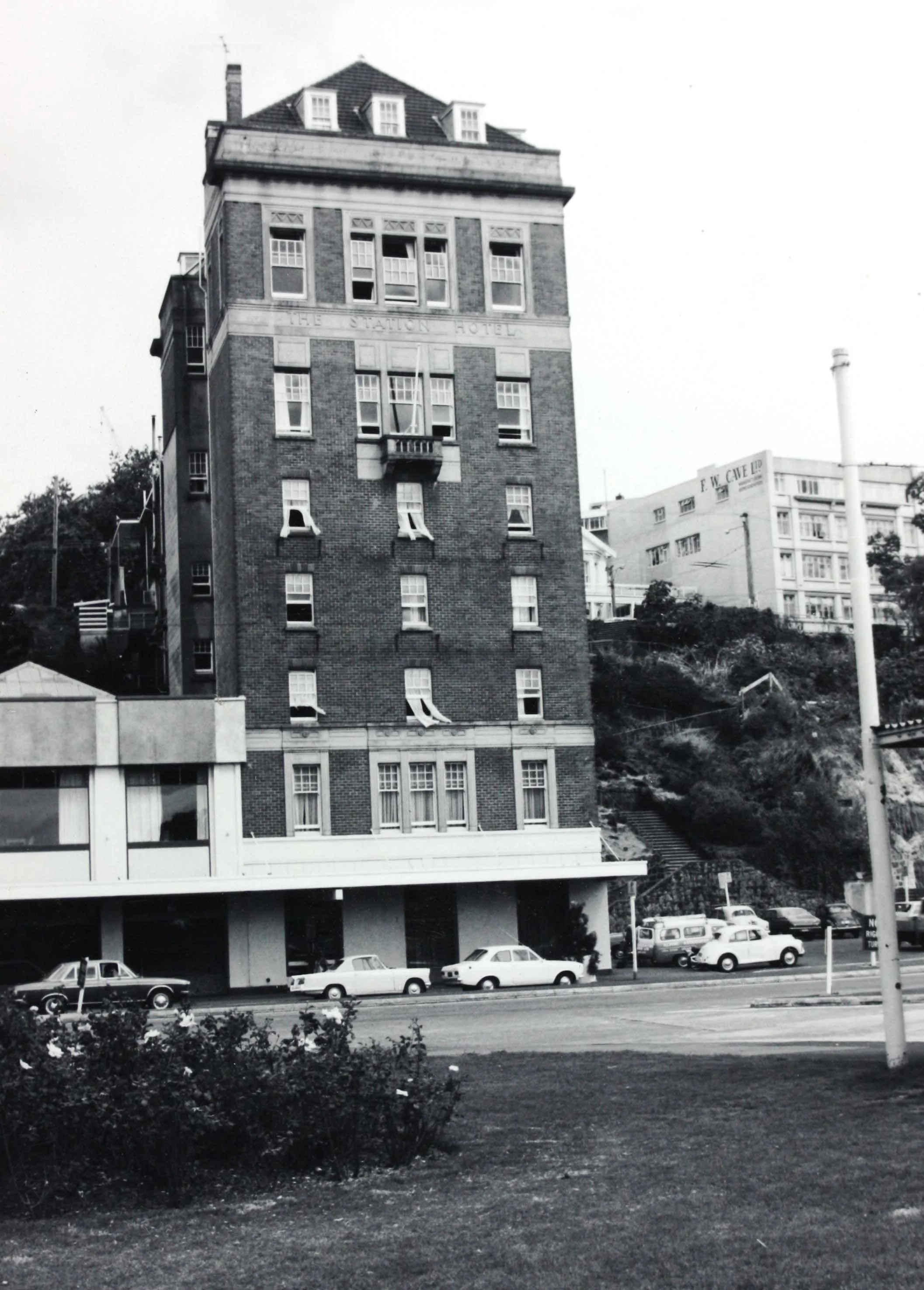 Black and white photo showing the front of a tall building