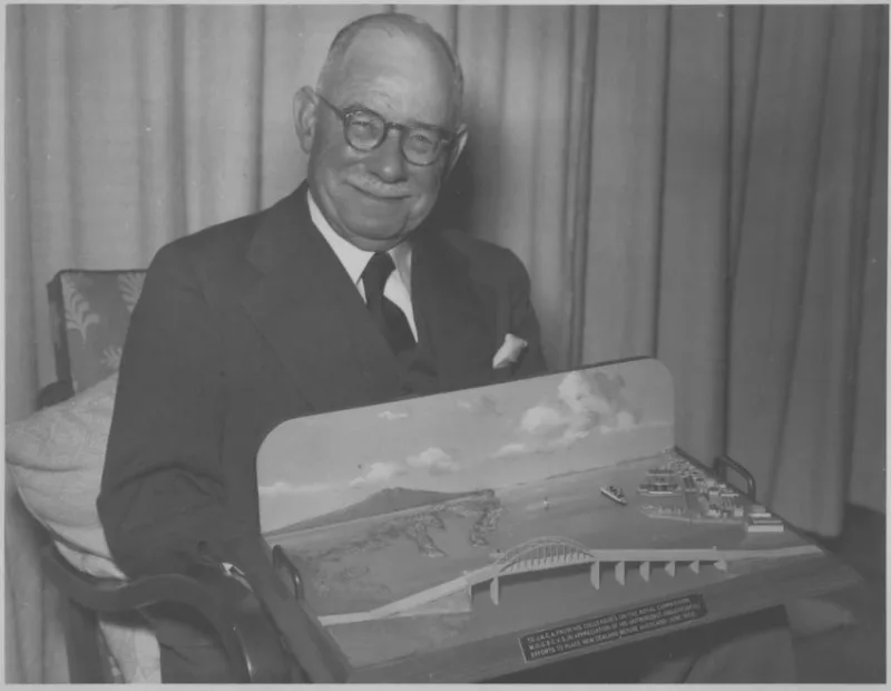 An image of Sir John Allum with model of Auckland Harbour Bridge