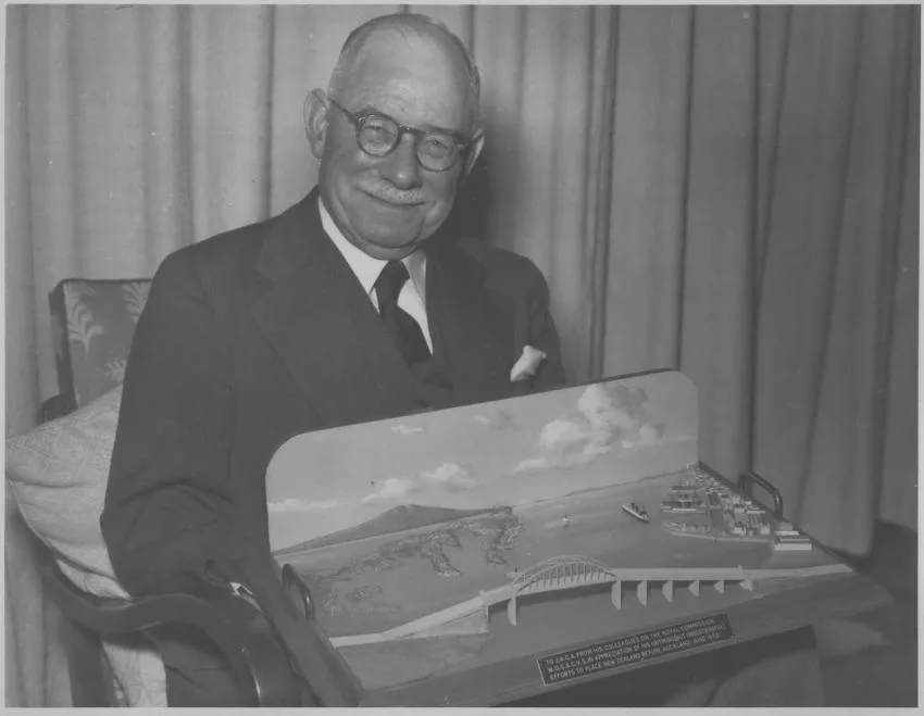 An image of Sir John Allum with model of Auckland Harbour Bridge