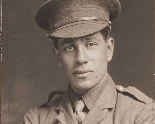 A portrait of Captain W. H. Stainton with his arms folded, wearing his uniform.
