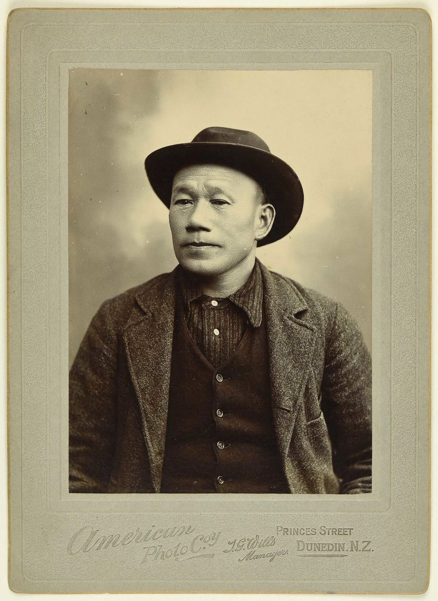 Sepia photo portrait of a Chinese man with wide brimmed hat
