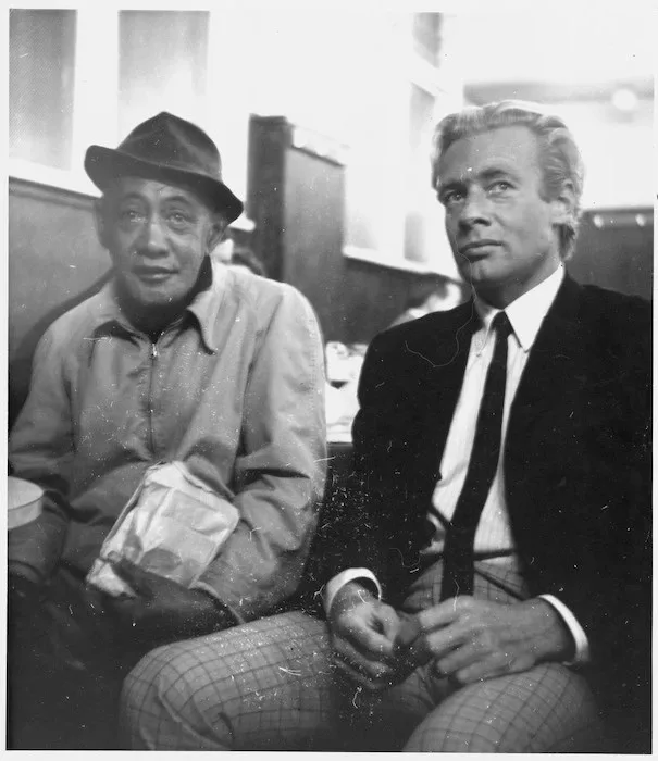 Black and white photograph of 2 men seated next to each other.