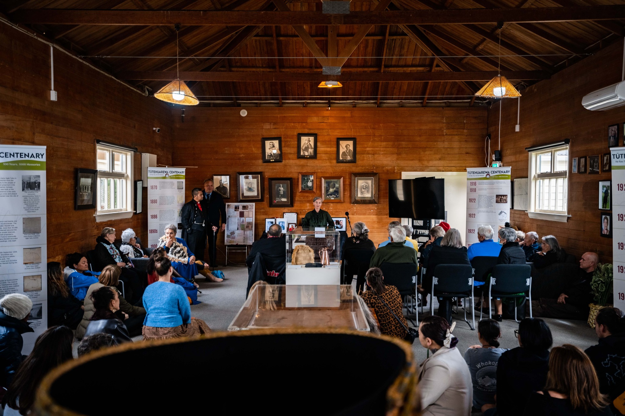 Helen Brown stands at a podium and addresses the audience