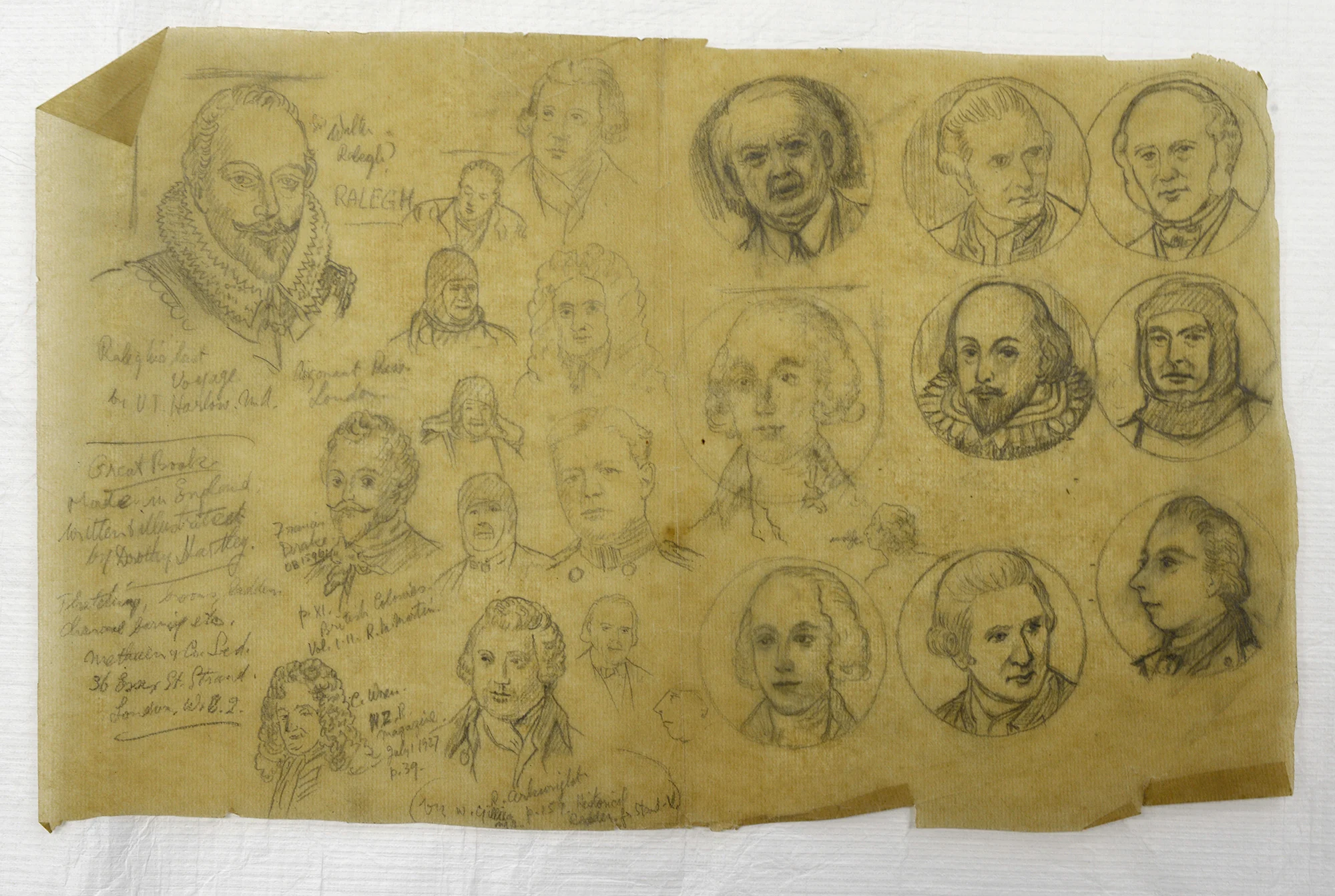 Detailed pencil drawing of faces of men with some handwritten text on the left drawn on an old yellowed paper 