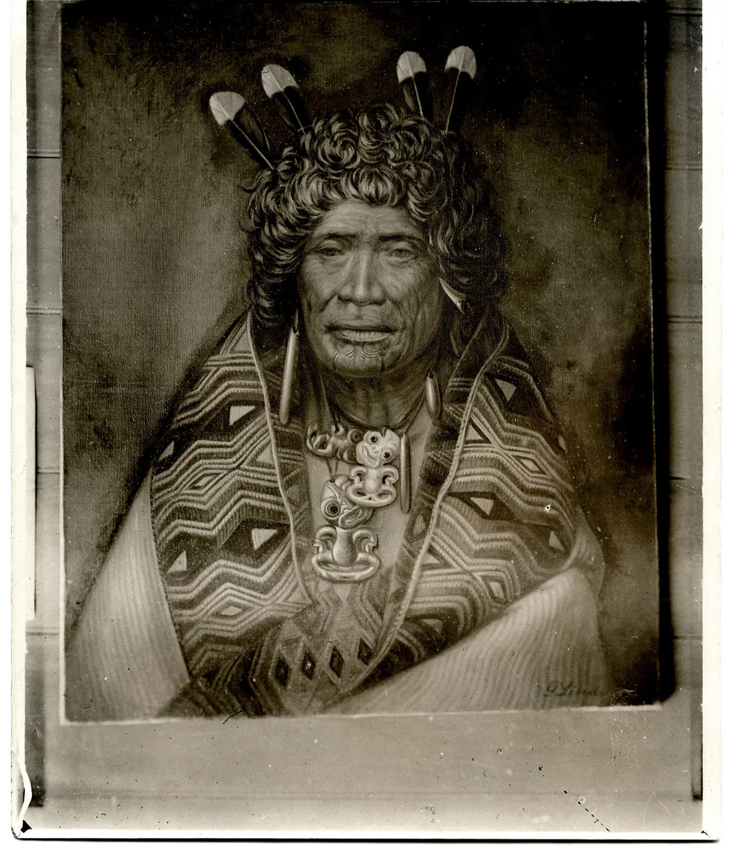 A portrait of a woman Māori leader wrapped in a cloak, she wears several pieces of pounamu and 4 huia feathers in her hair.