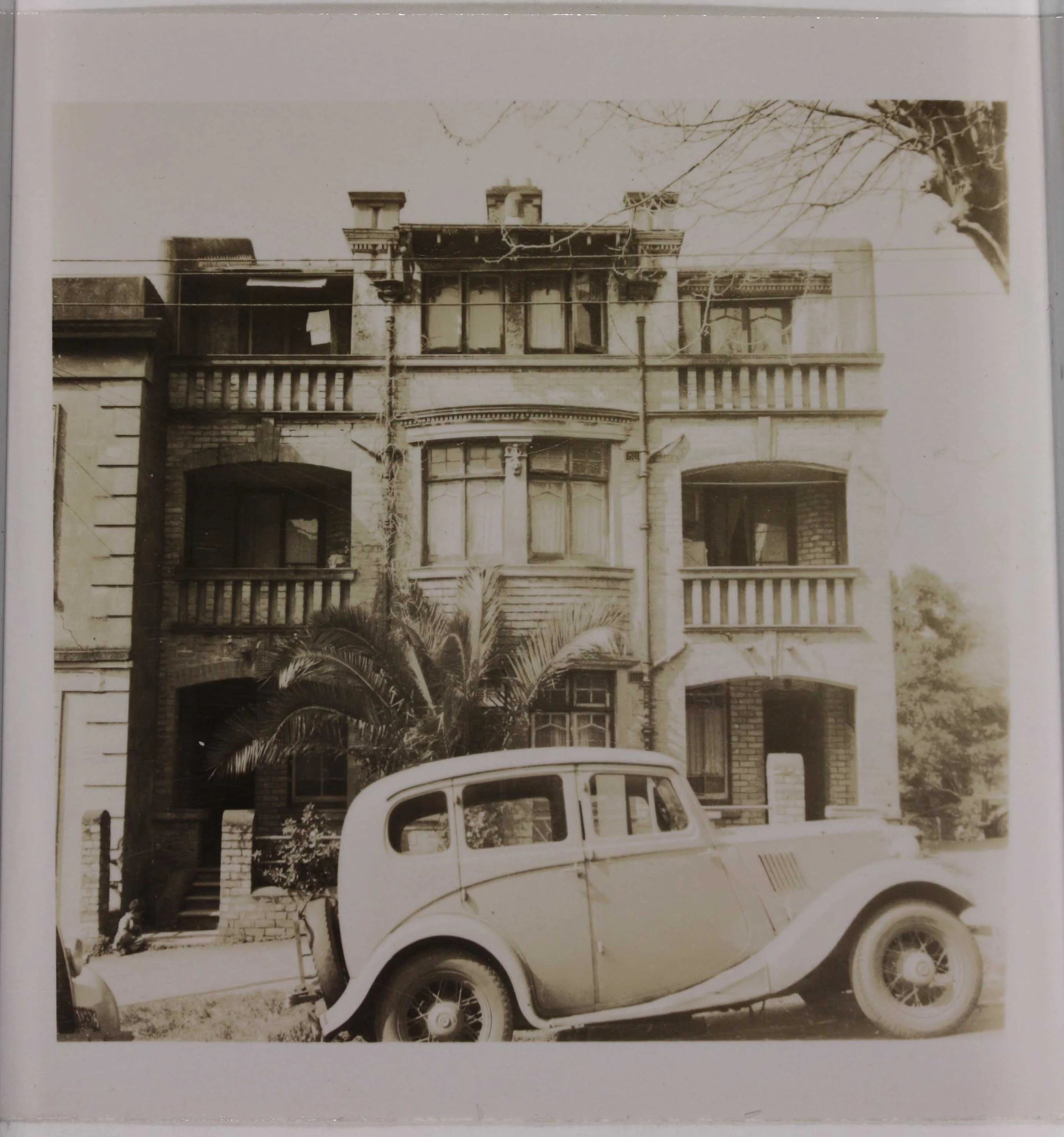Sepia photo from the street of a three story building