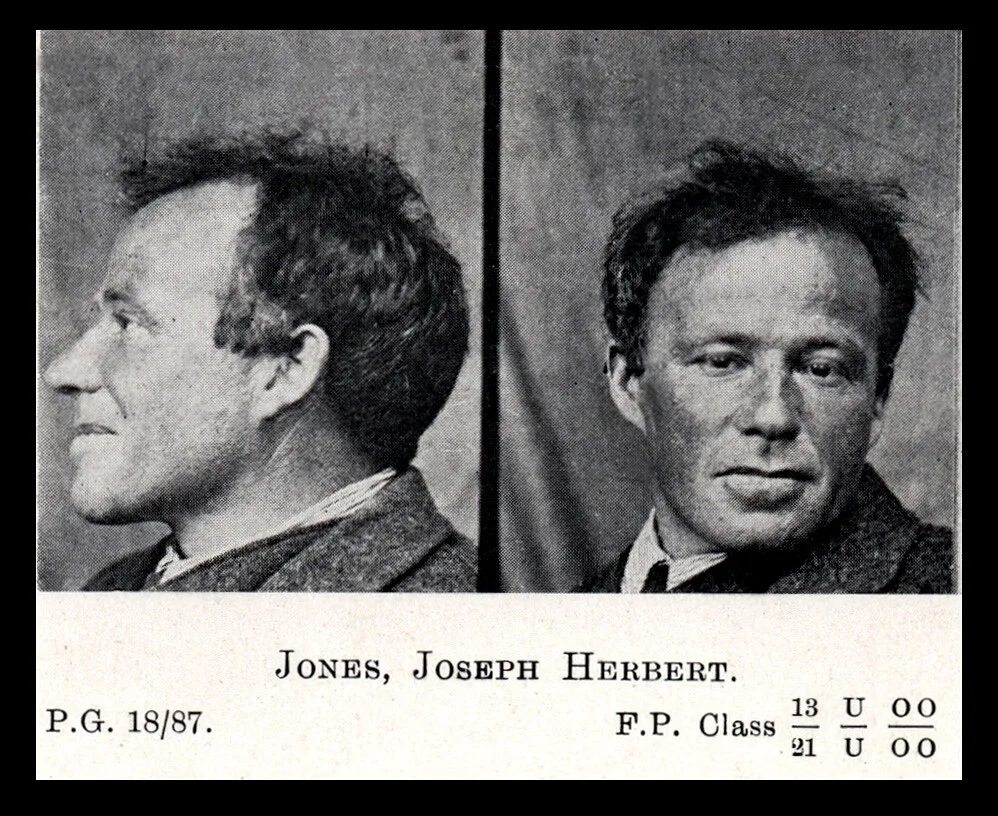 Black and white mugshot of a man