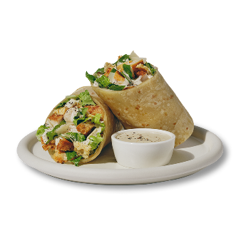 Chicken Caesar Wrap on a white plate with side of caesar dressing