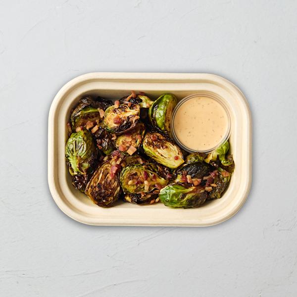 Sweetgreen roasted Brussels sprouts with bacon and a side of dipping sauce.