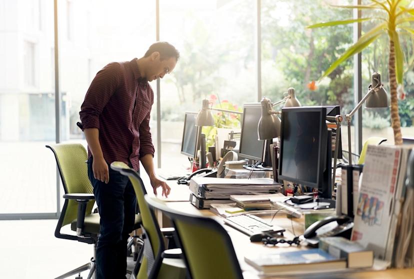 Employer looks over empty desk