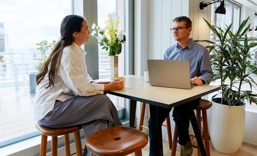 A manager checks in with an employee