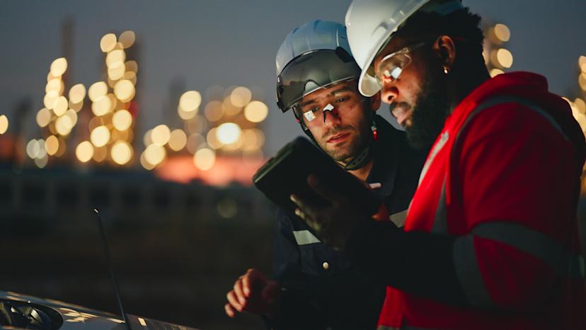 Two employees review data at night. 