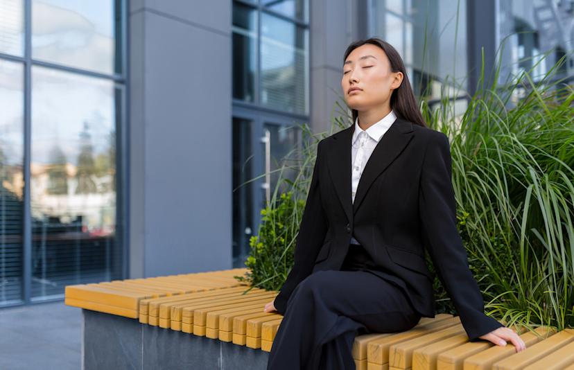 Businesswoman relaxing outside an office building