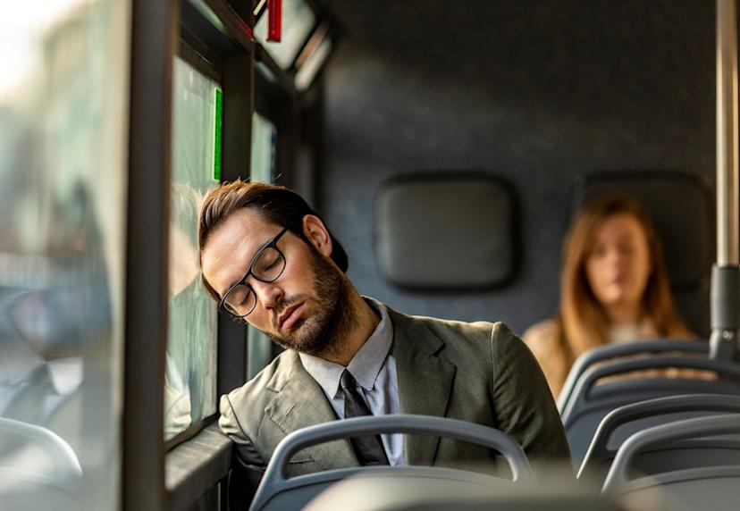 Worker asleep on a bus