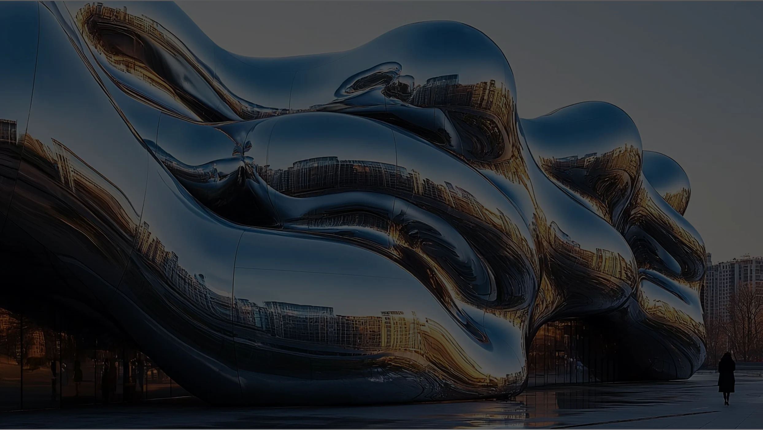 Fluid architectural facade in polished stainless steel that reflects the surrounding urban buildings and the sunset lights.