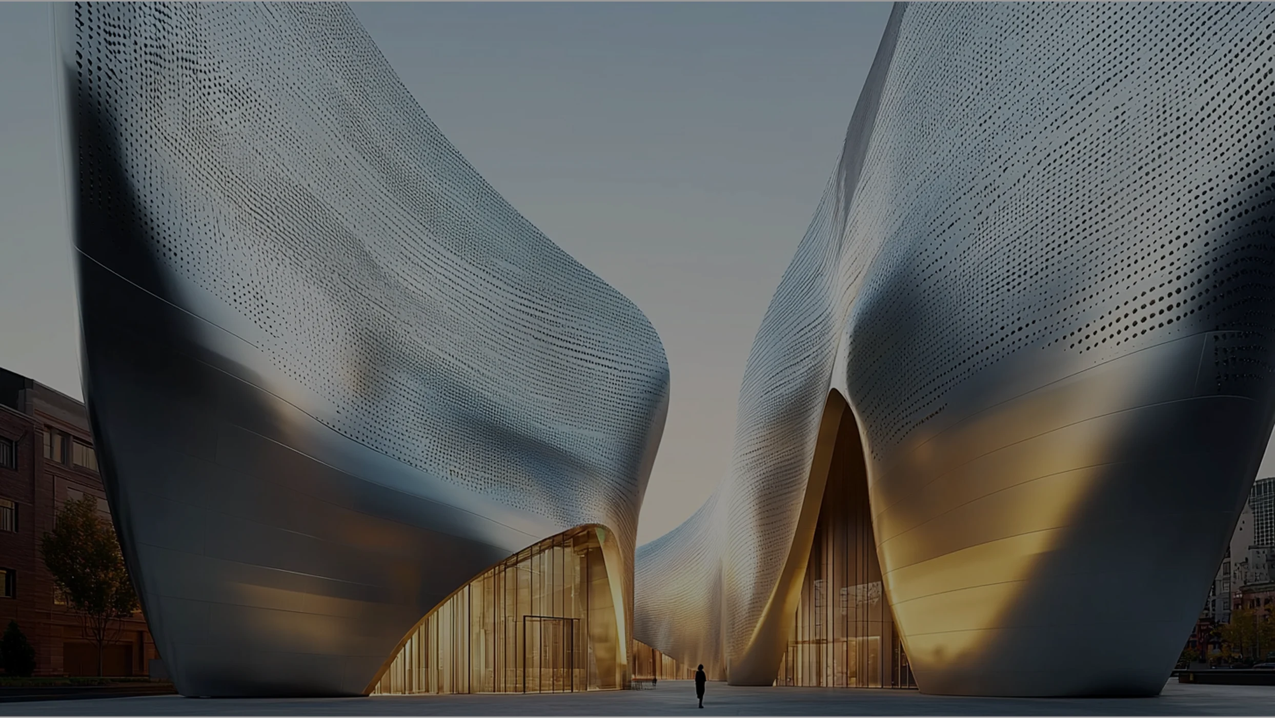 Monumental entrance to the Walt Disney Concert Hall with curved stainless steel walls and a person standing.