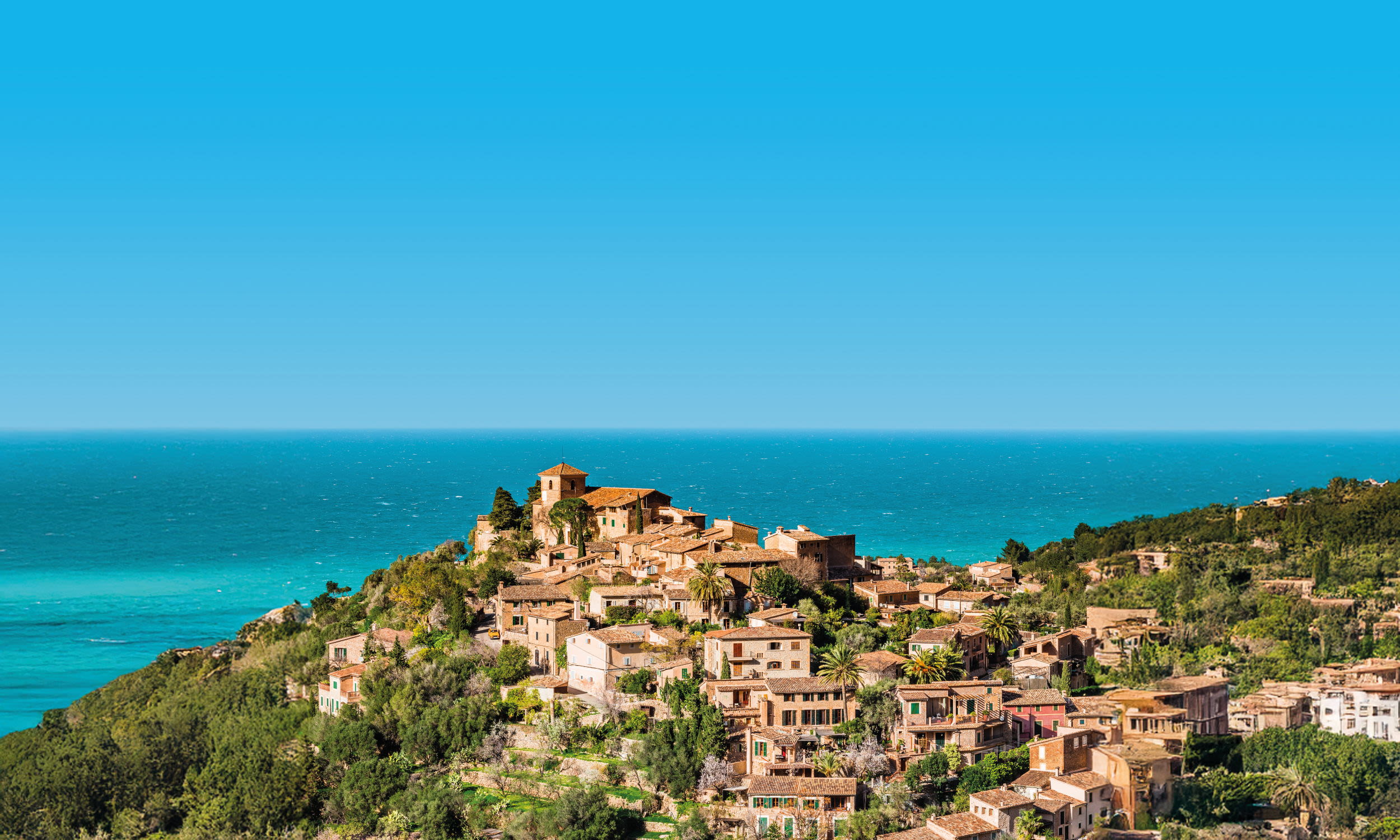 Mediterranean coastal town with historic buildings and blue skies