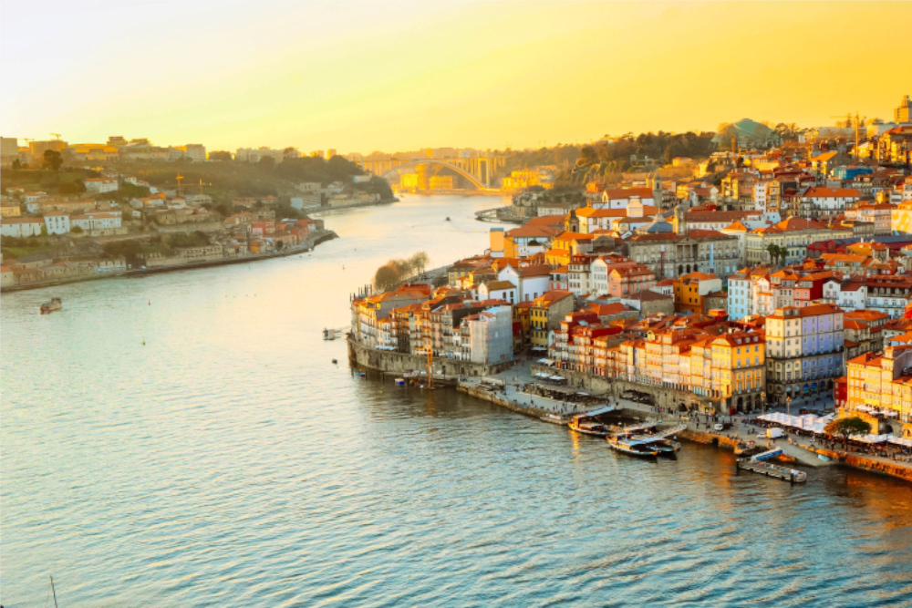 Blick auf Porto bei Sonnenuntergang, Fluss Douro, bunte Häuser.