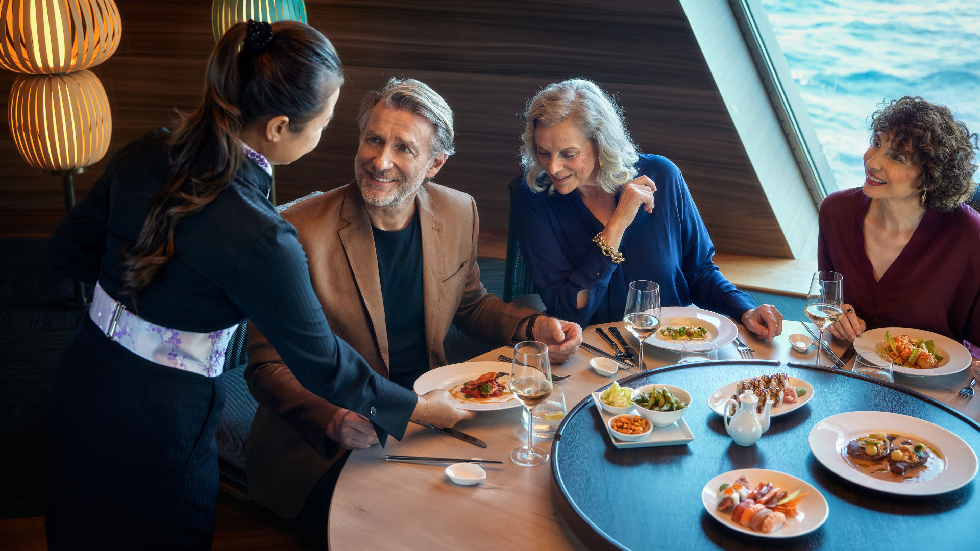 Menschen essen in einem eleganten Restaurant auf einem Kreuzfahrtschiff der Mein Schiff® Flotte.